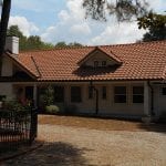 Stone house with custom Terra Cotta roofing done by Creed & Garner Roofing Company Inc. in Aberdeen, NC.